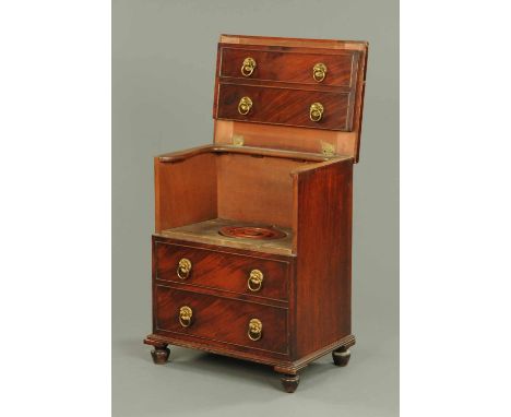A George III mahogany commode, modelled as four drawers with brass drop handles with circular backplates and raised on short 