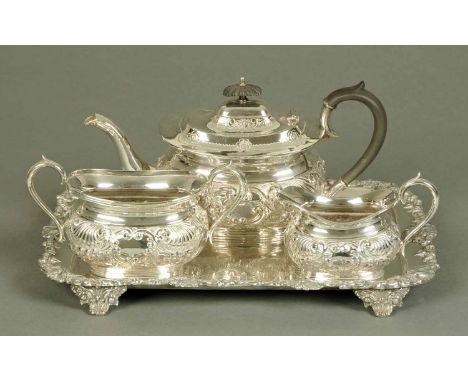 A Victorian silver plated tea service, repousse with foliate scrollwork and with rectangular tray.