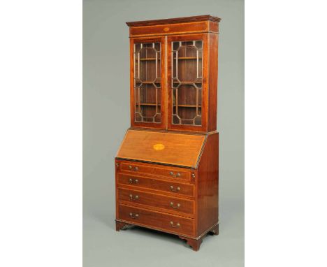 An Edwardian inlaid mahogany bureau bookcase, with moulded cornice above a crossbanded, boxwood and ebony strung frieze with 