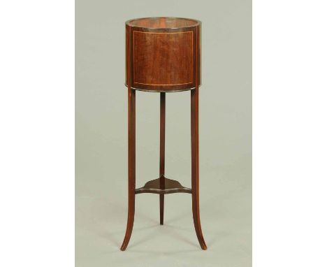 An Edwardian inlaid mahogany cylindrical plant stand, with low shelf and slightly splayed feet.  Diameter 12.5 ins. 