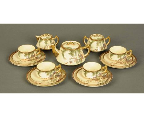 A Japanese Satsuma handpainted tea service, four cups, saucers and plates, teapot, sucrier and lidded jug, each piece with re