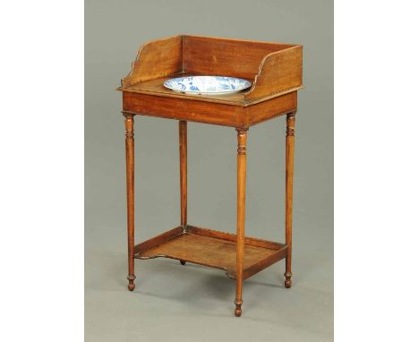 An early 19th century mahogany washstand, with splash back, with blue and white transfer printed basin with shipping scene an