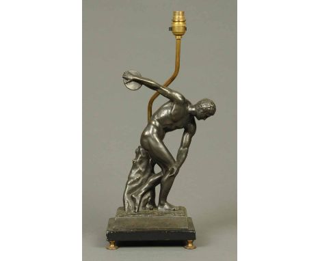 An early 20th century spelter figural lamp, discus thrower, raised on a rectangular base with metal feet.  Height of lamp inc