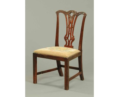 A George III mahogany Chippendale style side chair, with yoke shaped top rail, carved splat back, drop in seat and raised on 