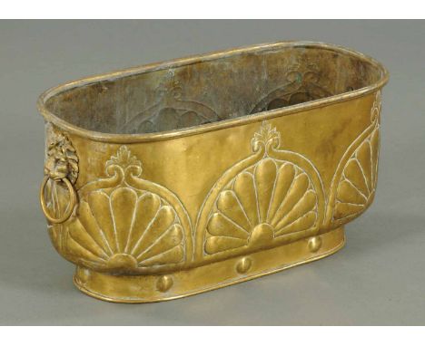 A 19th century brass planter, embossed with lion mask backplates to each carrying handle.  Width 20 ins. 