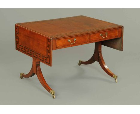 A Regency mahogany sofa table, with ebonised Greek key decoration, fitted with two frieze drawers and two opposing dummy draw