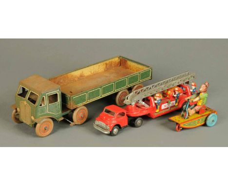 A collection of tinplate toys, monkey on trolley, articulated fire engine, truck and flat bed wagon. 