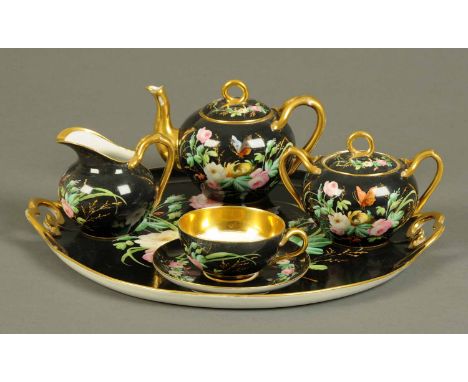 An early 20th century German porcelain Bachelors tea service, comprising tray, teapot, sugar basin, sucrier, cup and saucer. 