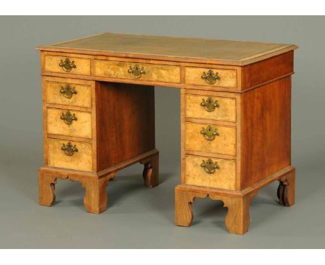 A Victorian walnut pedestal desk, with brown tooled leather writing surface, moulded edge and three frieze drawers, each pede