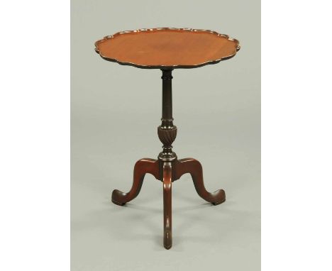 A mahogany tripod table, with Chippendale style top, turned centre column and three downswept legs terminating in pad feet.  