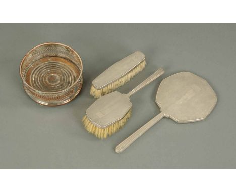 A silver backed Art Deco style table set, comprising hair brush, clothes brush and mirror, engine turned, Birmingham 1936, ma