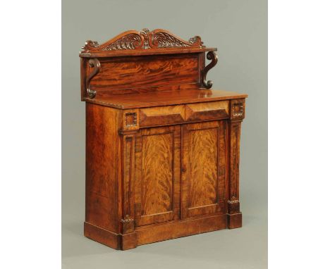 A William IV mahogany chiffonier, with carved back and shelf with scroll supports above the base fitted with a single drawer 