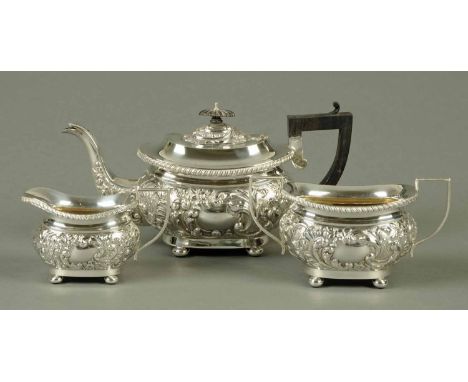 A three piece silver tea service, repousse with foliate scrollwork, Birmingham 1906, 740 grams (see illustration). 