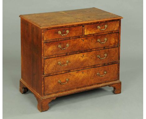 A George III yew wood crossbanded chest of drawers, either burr oak or elm, with quarter veneered top, yew wood banding and a