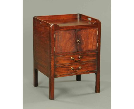 A George III mahogany tray top commode, fitted with a pair of panelled cupboard doors and two false drawers with brass drop h