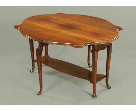 An early 20th century rosewood Sutherland table, of shaped outline and raised on shaped legs united by a raised shelf termina