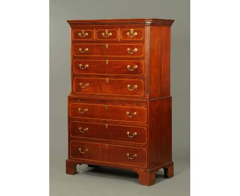 A George III mahogany tallboy, in two sections, the top half with a moulded dentil cornice above three short and three long g