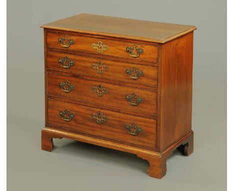 A George III mahogany chest of drawers, with moulded edge above four long graduated drawers with brass drop handles, pierced 