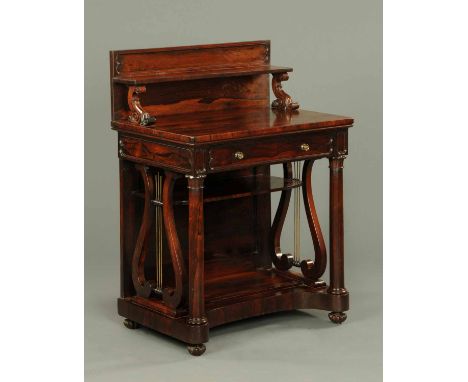 A Regency rosewood writing table, with rear upstand, shelf, frieze drawer, turned supports beneath, lyre sides and raised on 