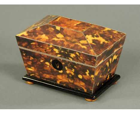 A simulated tortoiseshell sarcophagus shaped tea caddy.  Width 6 ins. 