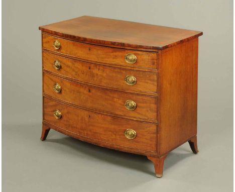 A George III mahogany bowfronted chest of drawers, four long graduated drawers with brass drop handles with embossed oval bac