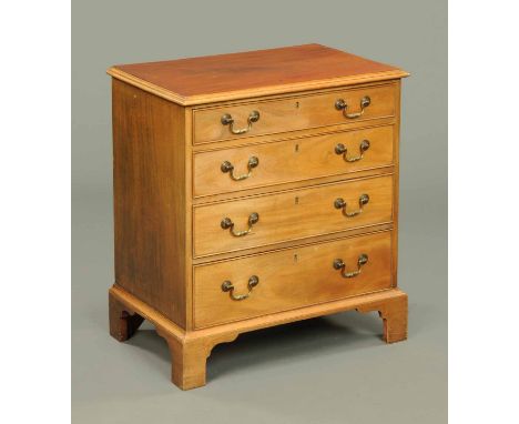 A George III style mahogany chest of drawers, circa 1910, with moulded edge above four long graduated drawers with brass drop