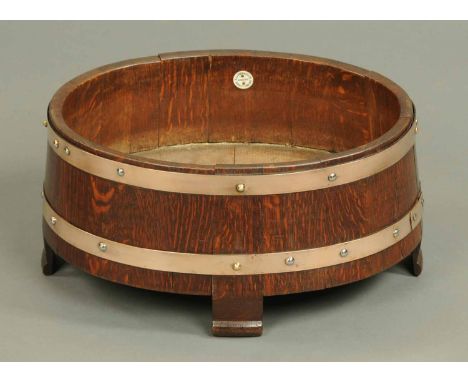 A brass bound wooden planter, oval, bearing plaque "R.A. Lister & Co. Limited, Dursley, England".  Width 18 ins. 
