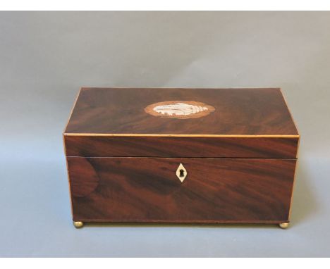 A George III mahogany tea caddy, with later inlaid shell, and glass mixing bowl