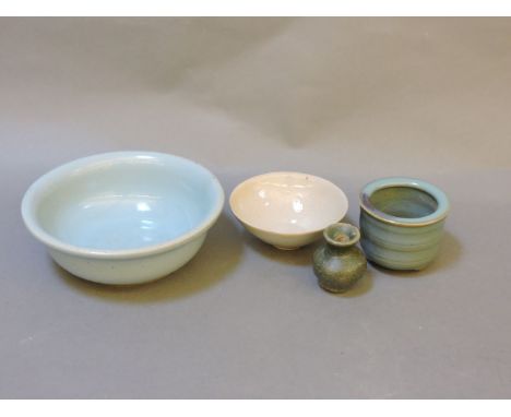 Four Chinese ceramic items, a light blue bowl, a cream glaze dish, a turned pot and a small vase, tallest 5.5cm