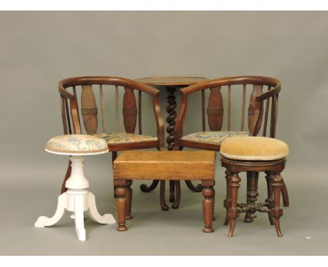 A pair of Edwardian bow back chairs, a Victorian mahogany bidet, two piano stools and an occasional table with a barley twist