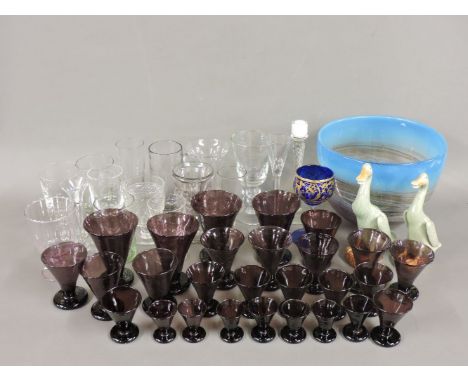 A collection of glassware, amethyst beakers, a modern glass bowl, and a pair of Chinese ducks