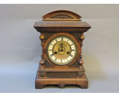 A Victorian walnut mantle clock