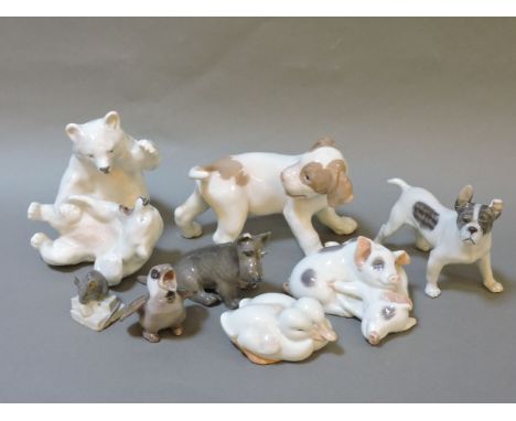 A collection of Royal Copenhagen ceramic figures, to include polar bear cubs, a fox hound puppy, further dogs, etc.