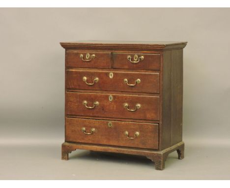 An 18th century oak chest of drawers, on bracket feet