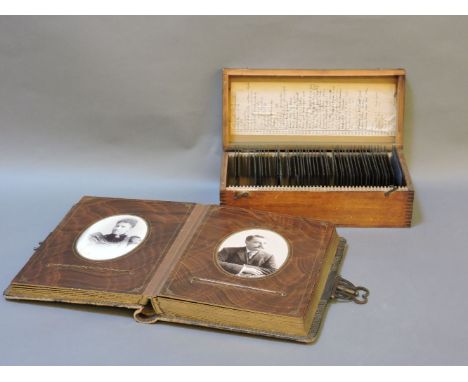 A photo album and approximately 50 portrait photos, and various glass negatives, in a box