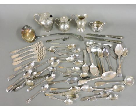 A Victorian silver lidded milk jug, a silver cream jug with a cast handle, a squat milk jug, a plated cream jug, and other si