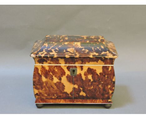 A George III tortoiseshell tea caddy, of casket form on ball feet, 18cm wide