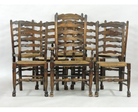 A set of eight oak and rush seated ladder back dining chairs, two carvers and six standards