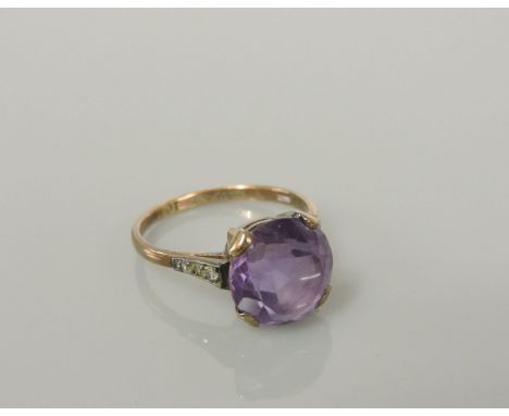 A single stone amethyst gold ring, with diamond set shoulders, marked 9ct