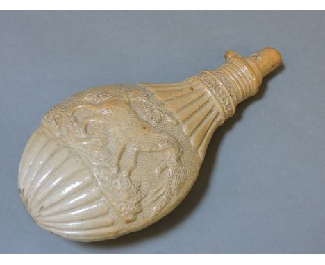 A stoneware powder flask, 19th century, moulded with hunting dogs, 30cm long