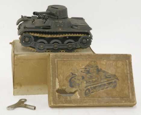 A Gama tinplate clockwork tank, with rubber tracks, two machine guns, lithographed DRGM in US zone Germany, with axe and shov