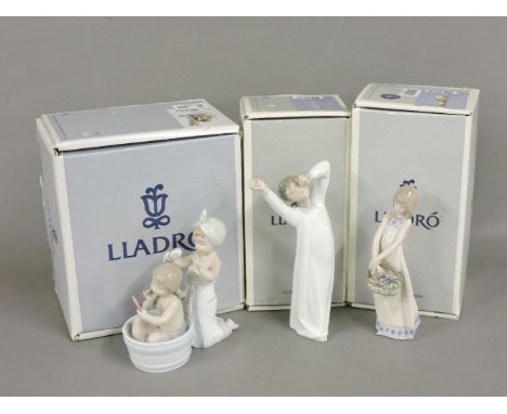 Three Lladro figurines, 'Floral Treasures', 'Bathing Beauties', and 'Boy Awakening'