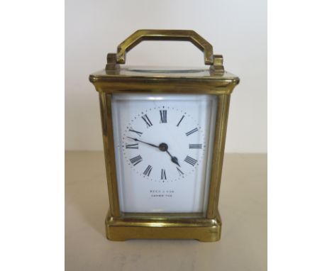 A French brass 8 day carriage clock timepiece retailed by Harrods London on dial, 12cm tall, generally good, crack to dial, r