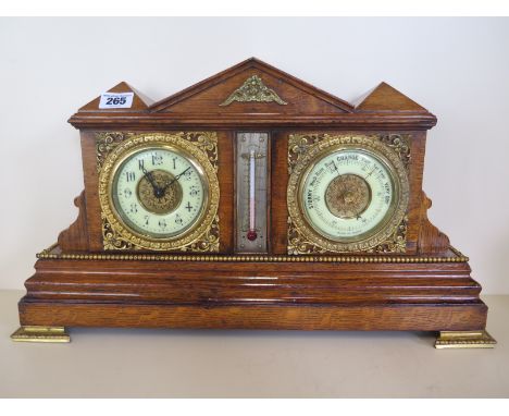 An 8 day oak case desk clock with thermometer barometer brass feet, brass decoration, 27cm tall x 47cm wide, working order, c
