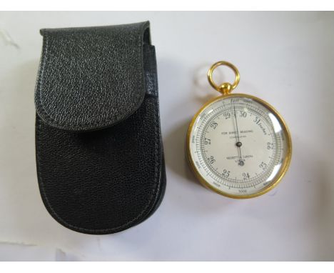 A pocket barometer by Negretti and Zambra London, the scale from 22 to 31 for direct reading, gilded case with leather holder