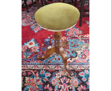 A 19th Century piano stool in a tripod base 
