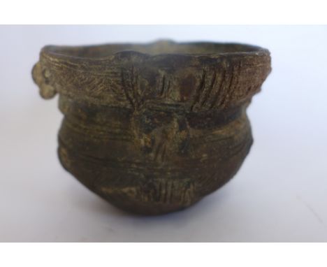 A Pre-Columbian or later vessel with comb tooth decoration, 8cm tall 11cm diameter, sound condition 