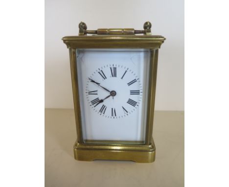 A French brass 8 day carriage clock striking the hours and half on coiled gong - 15cm tall working in saleroom, cracks to dia