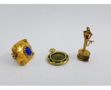 18ct gold pendant with coloured cabochons, a 9ct gold 'street lamp' charm and a yellow metal and green enamel locket (3)