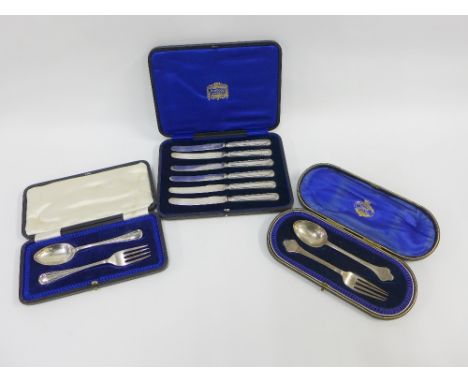Two early 20th century boxed silver fork and spoon sets together with a cased set of six silver handled knives (a lot) 